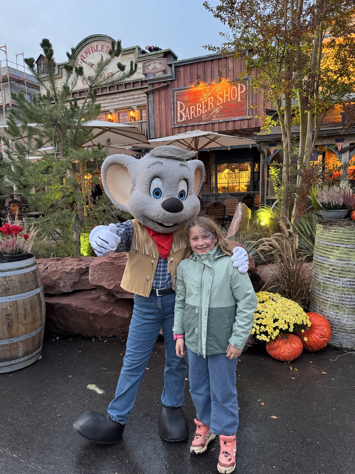 Mathilde with a costumed character at a theme park