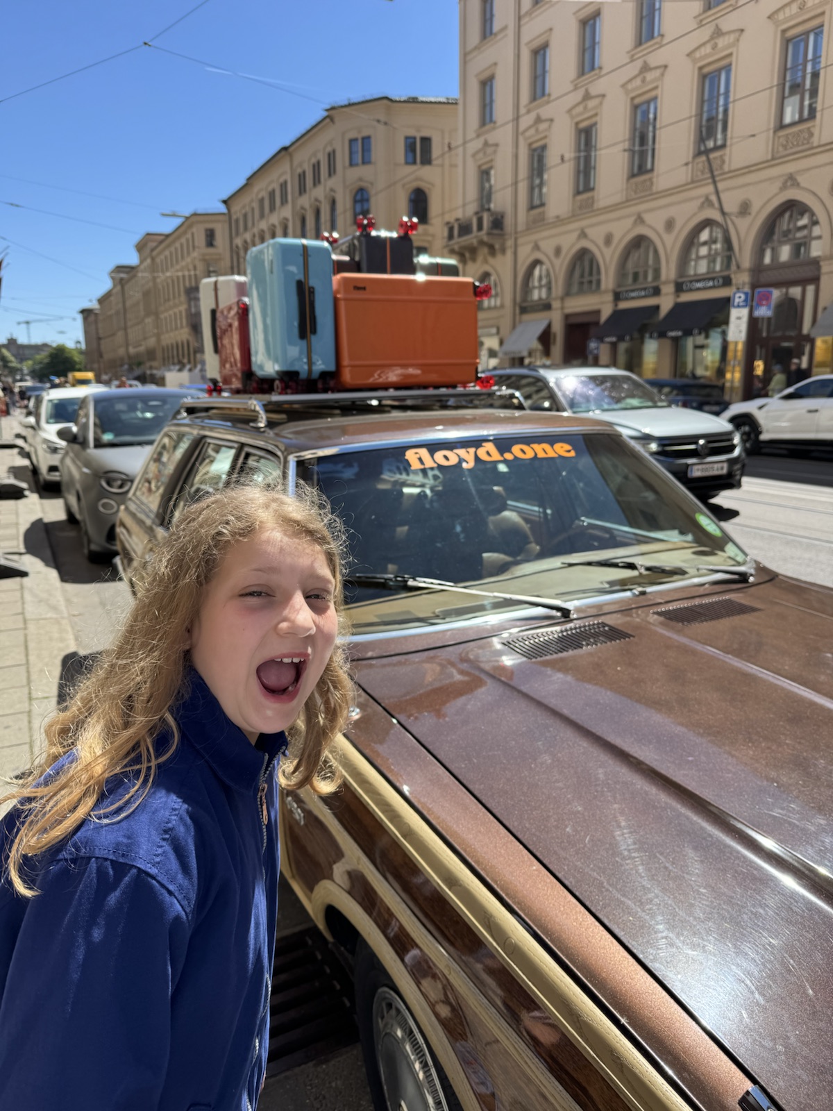 Mathilde laughing next to a vintage car