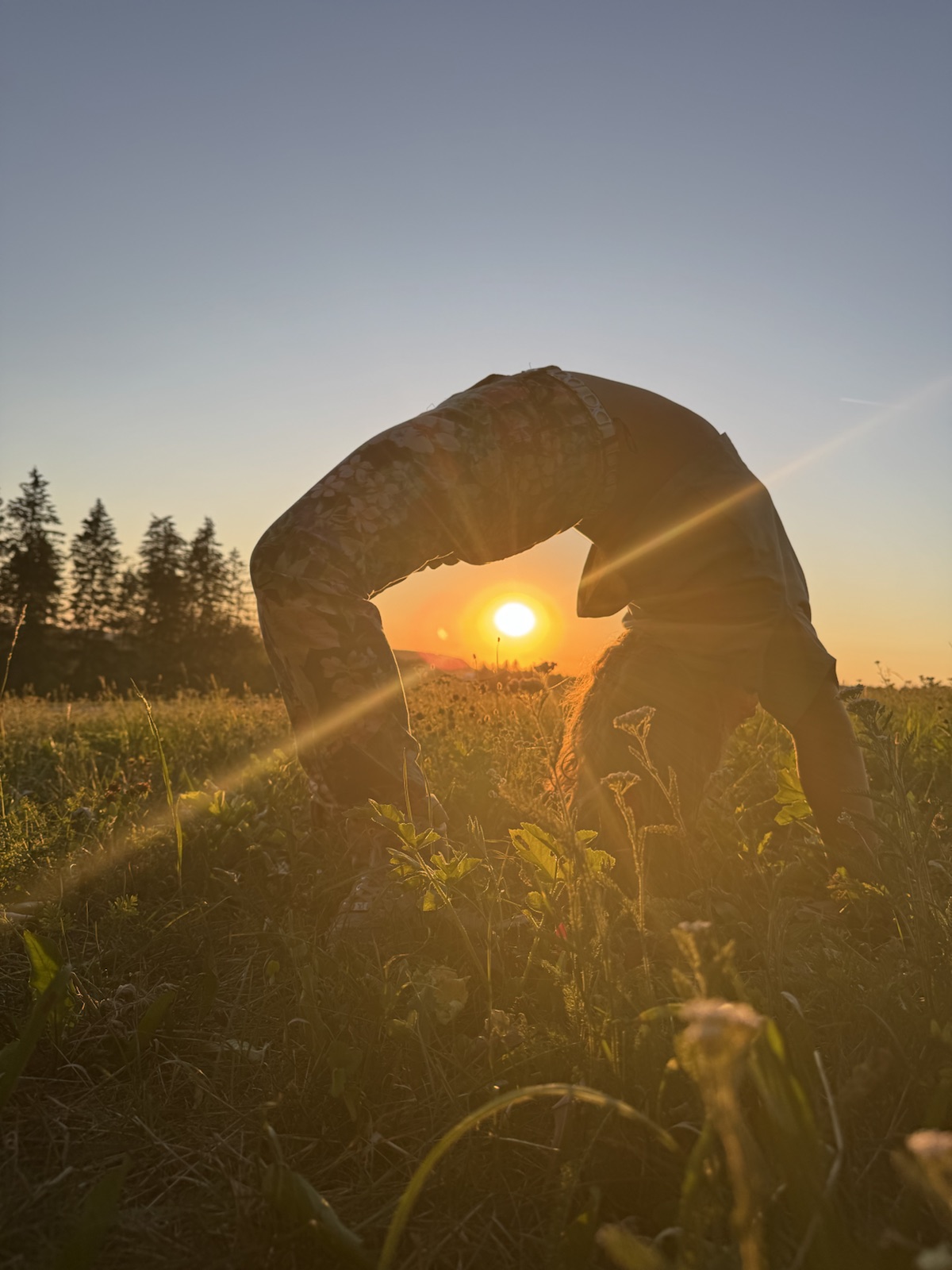 Mathilde doing a backbend at sunset