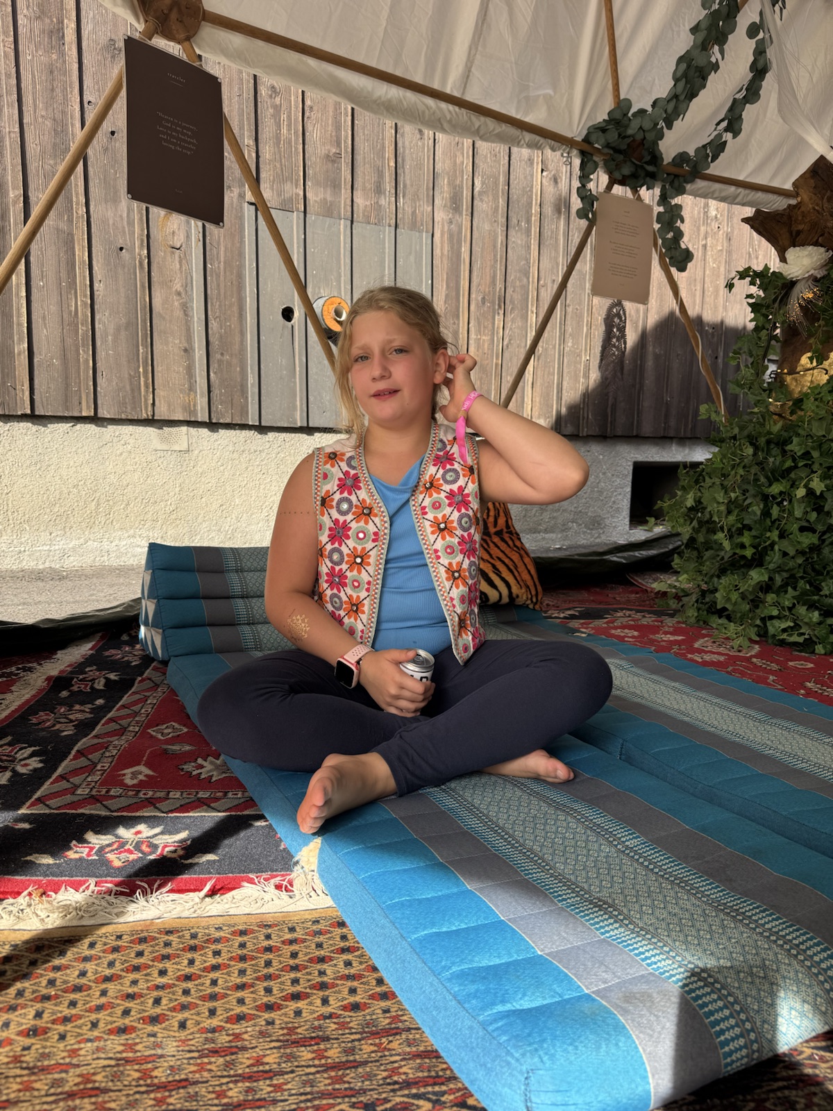 Mathilde sitting cross-legged in a bohemian lounge